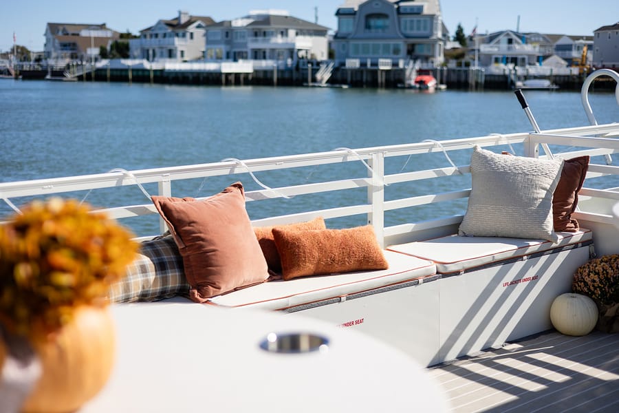 Cozy pillows on the boat's deck bench, looking out over the bay